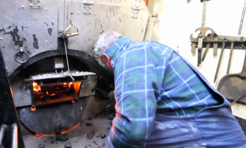 Shoveling coal in the boiler