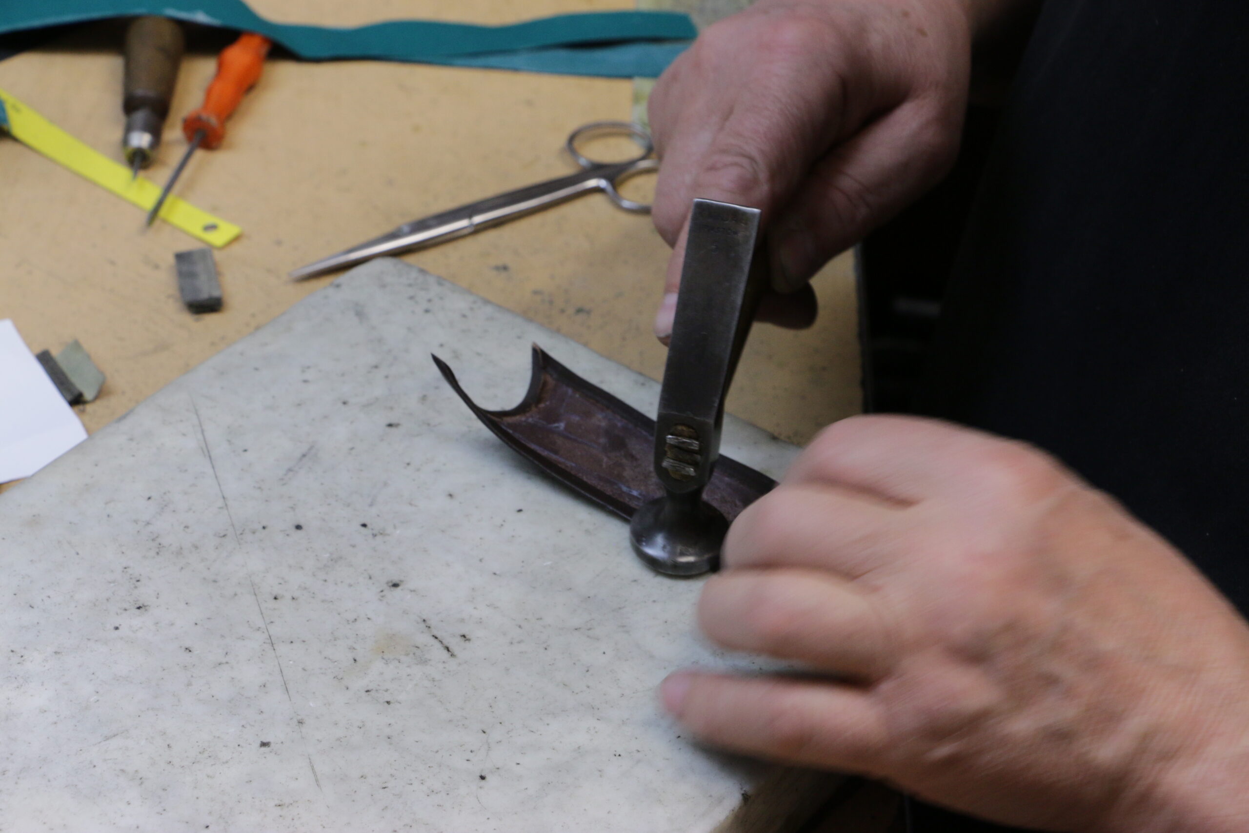 Shoemaker specializing in shoe uppers: folding leather edges (2)