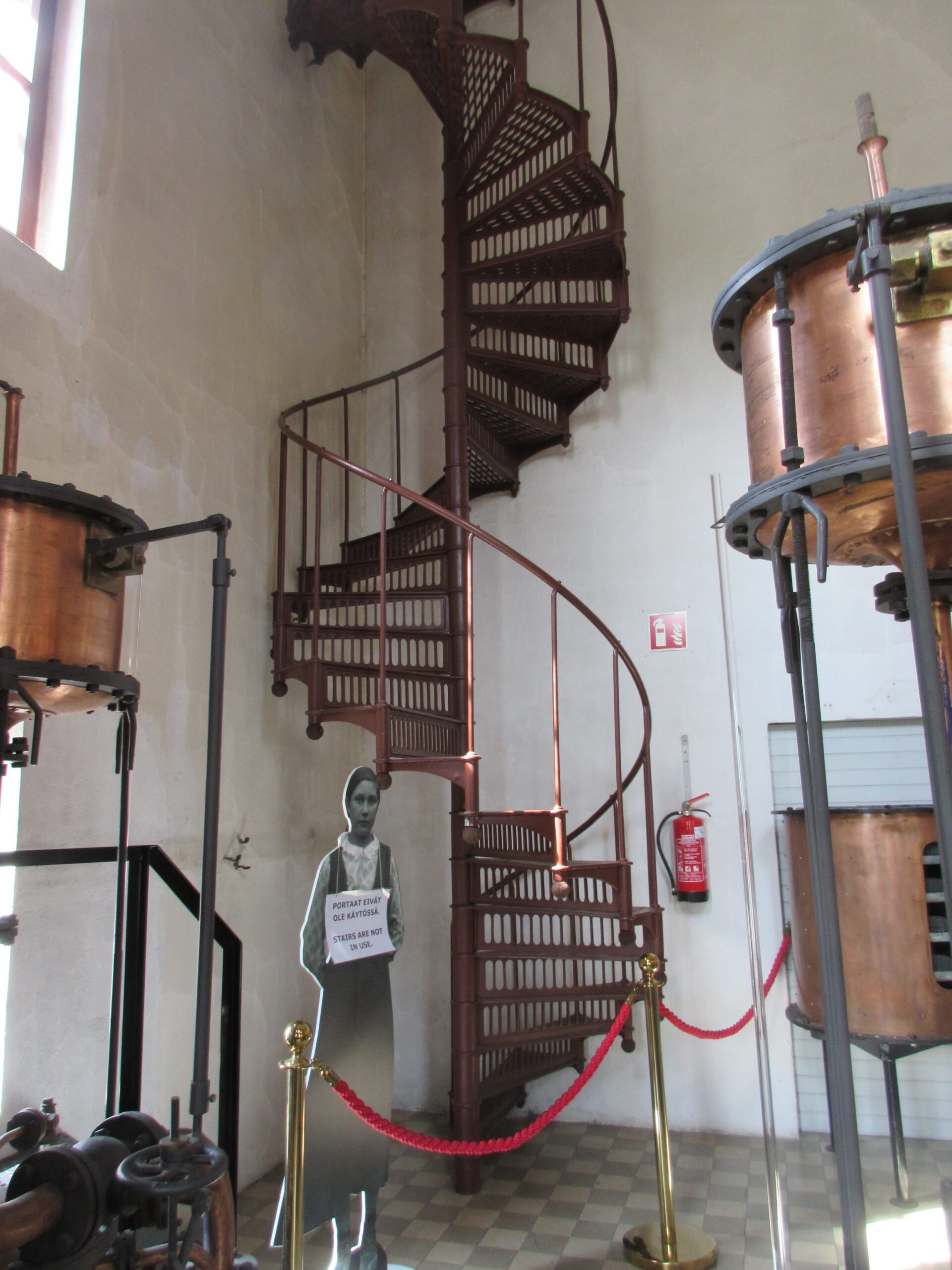 Running down the metal stairs at Alcoholic beverage plant in Rajamäki (Rajamäen Ryyppi -museum)